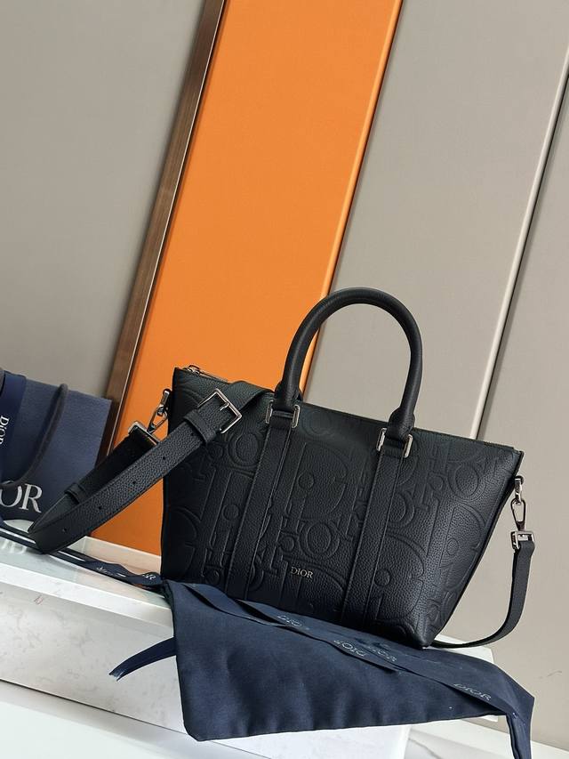 这款 Weekender 25 手袋设计经典高雅。Dior Gravity 印花效果皮革采用压花工艺将经典图案精致地呈现于黑色牛皮革之上，饰以 Dior 标志，